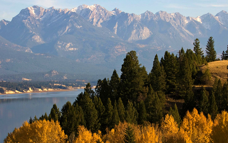 Image of mountains, forest and river in fall.