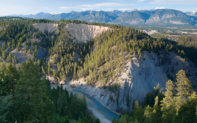 Ariel view of mountain range, and river in foreground.