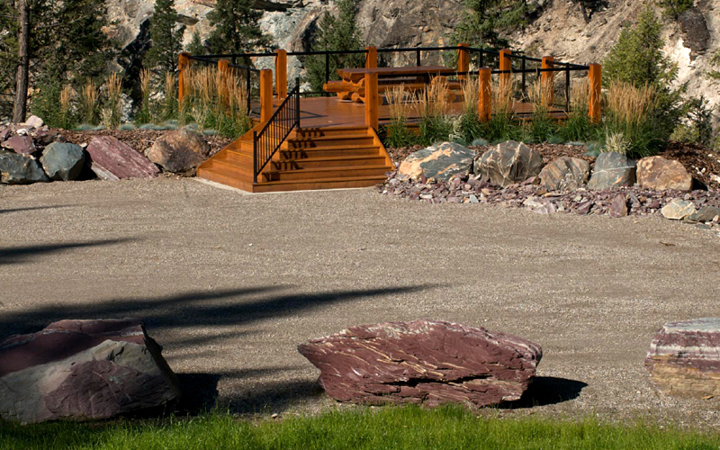 Image of raised cedar patio viewpoint, with log picnic table.