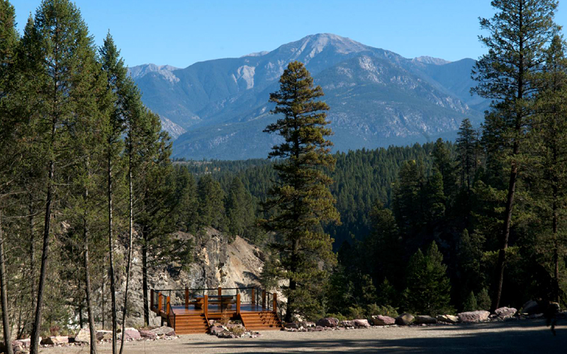 Image of viewpoint looking over forest and mountains.