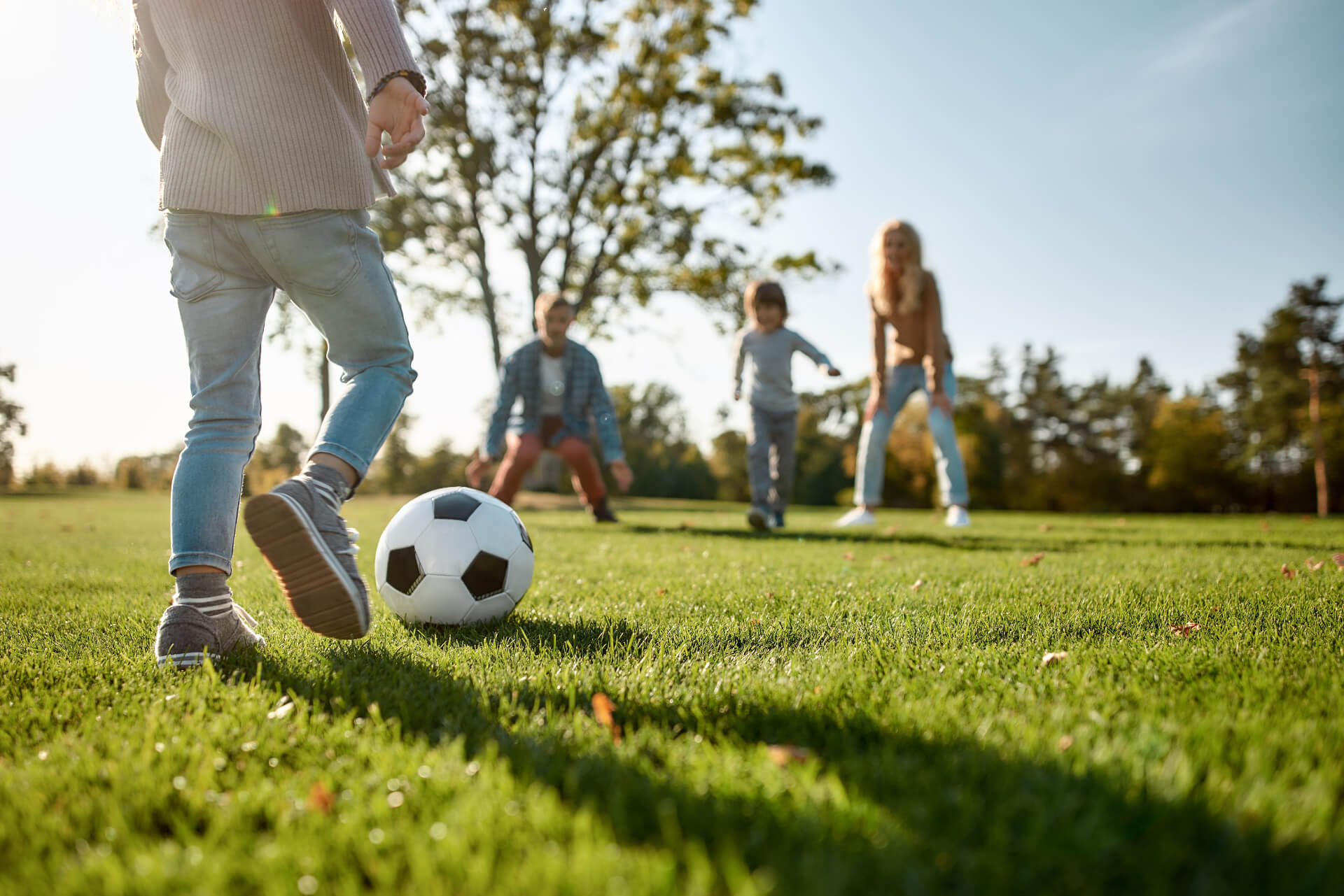 A family plays soccer in a park